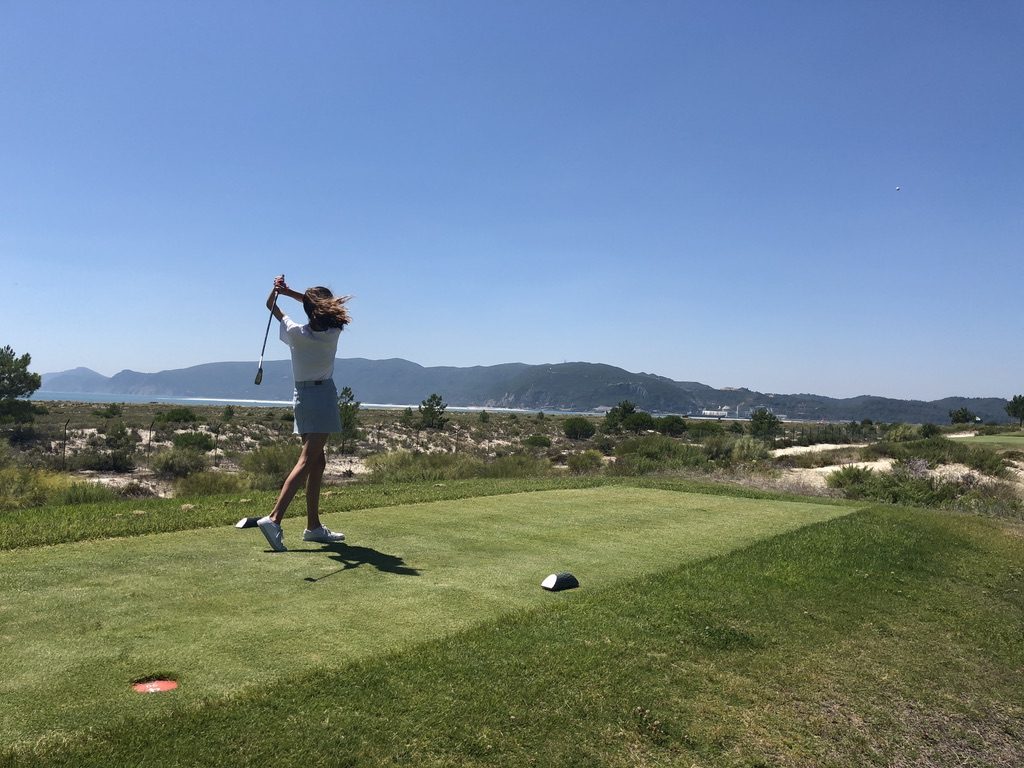 Golf swing with coastal view