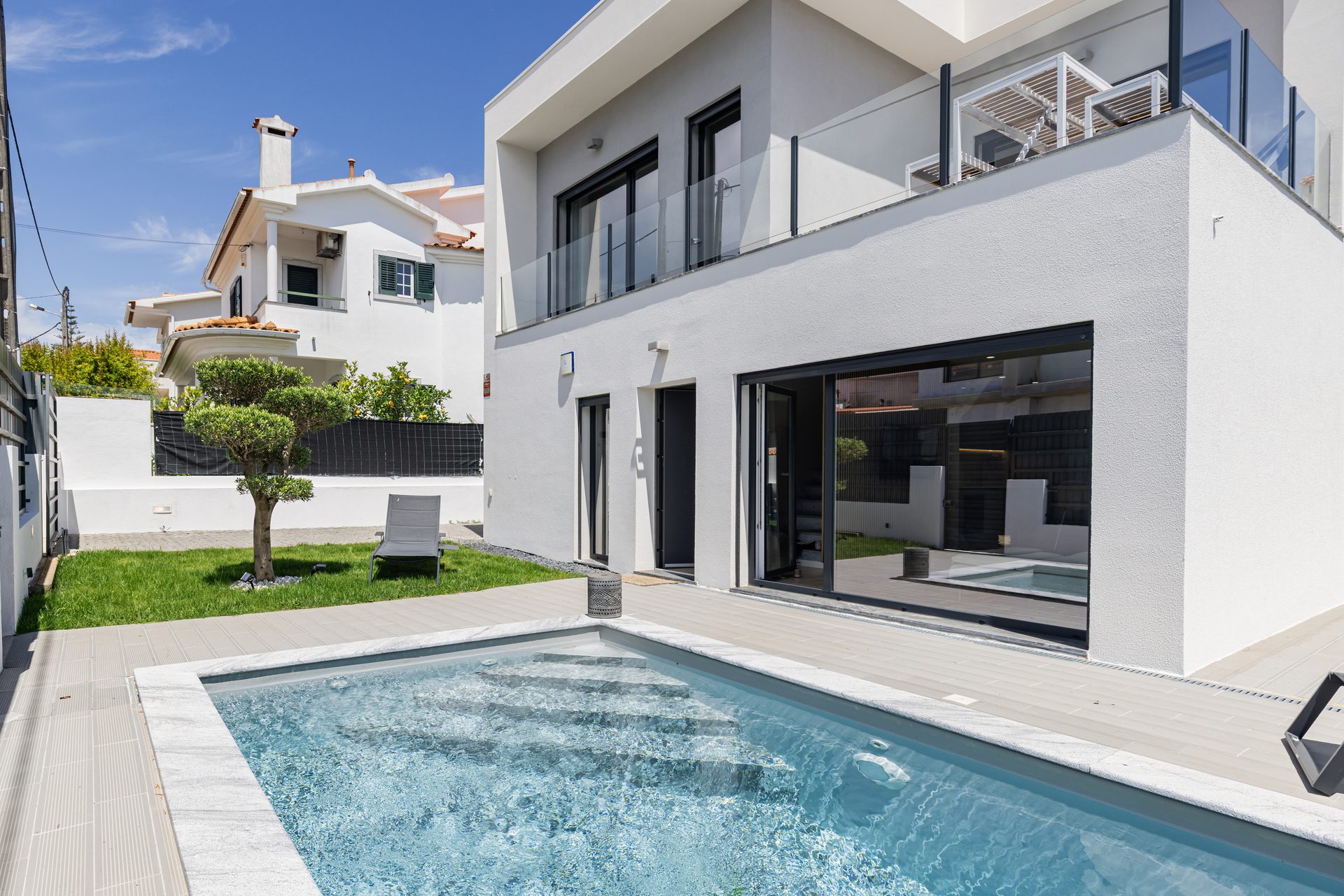 Private heated pool with deck and loungers