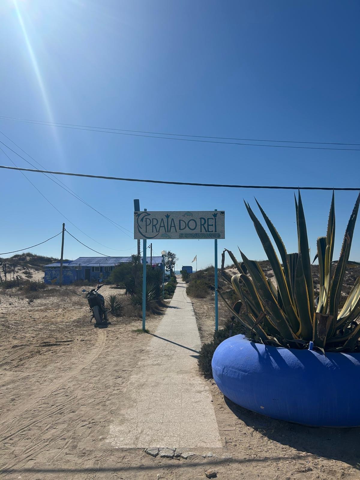 Beach entrance and sign at Praia do Rei near the villa
